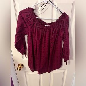 Maroon scoop neck or off the should blouse with details on the fabric